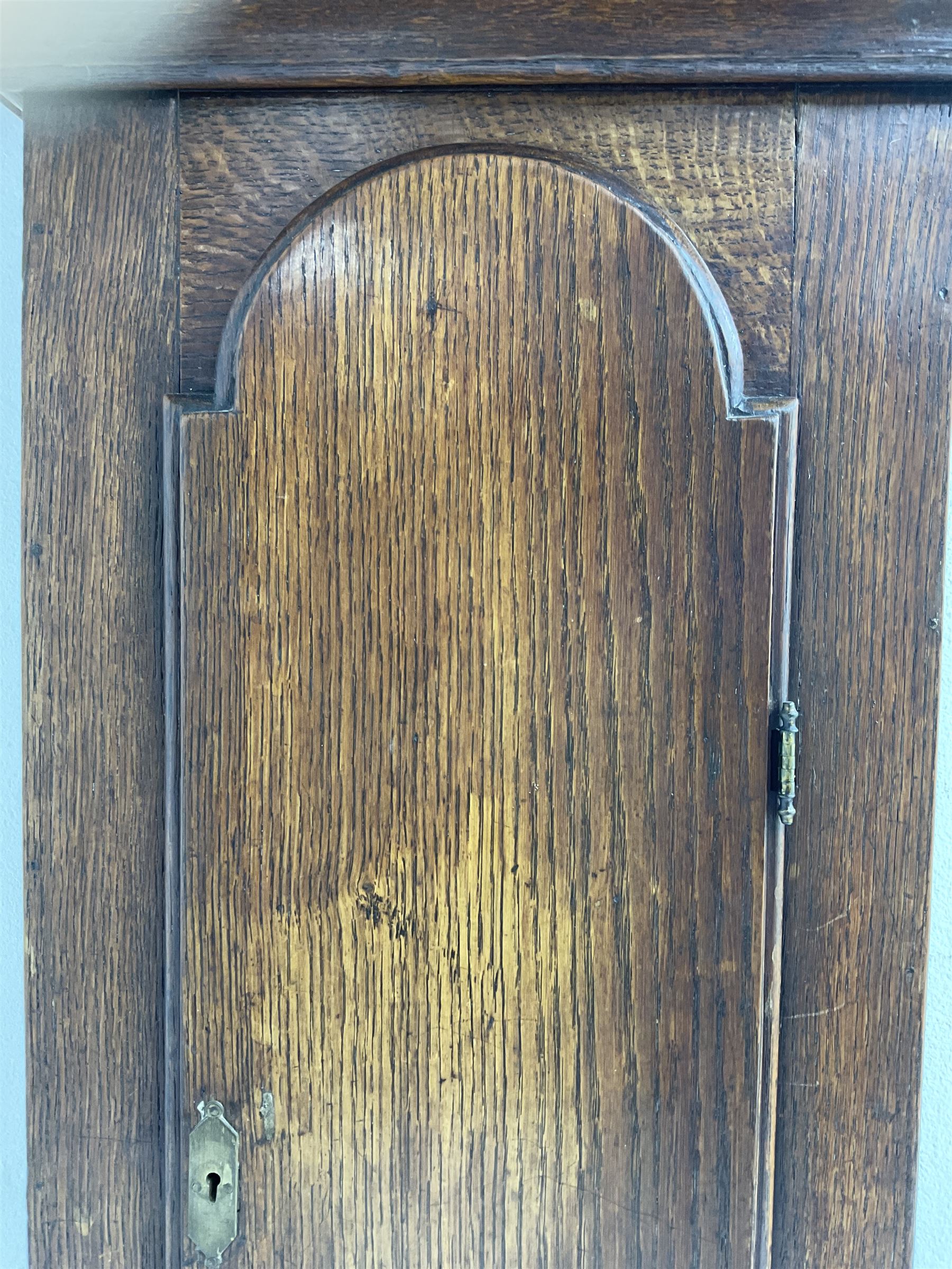 John Fletcher of Barnsley - Mid18th century 30-hour oak cased longcase clock, with a flat pediment and broad cornice, square hood door with attached pillars and gesso capitals, long trunk and conforming door with a break arch top, square plinth on a shaped base, brass dial with cast spandrels and engraved dial centre, chapter ring with Roman numerals and five minute Arabic’s, engraved calendar dial and steel hands, chain driven count wheel movement striking the hours on a bell. With pendulum and weight. The Fletcher family were a prolific family of clockmakers working in Barnsley (Yorks) during the 18th and early 19th century.
