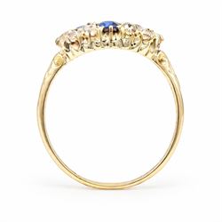 Victorian sapphire and diamond cluster ring, four oval cut sapphires, surrounded by eight old cut diamonds, with scroll design shoulders