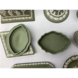 Collection of Wedgwood sage green Jasperware to include mantel clock decorated with classical scene, candlestick, trinket dishes, vase, lidded box etc, two with boxes, largest H20cm
