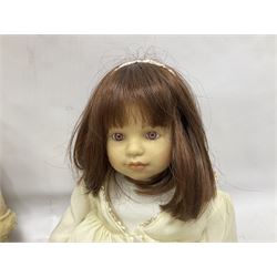 Two Zapf Creation limited edition designer collection dolls, by Brigette Paetsch, the first example with faux suede jacket, red jumper and denim skirt, no. 460, the second example 'Linda' in white dress with teddy bear accessory, no. 785, each signed B Paetsch, tallest L60cm