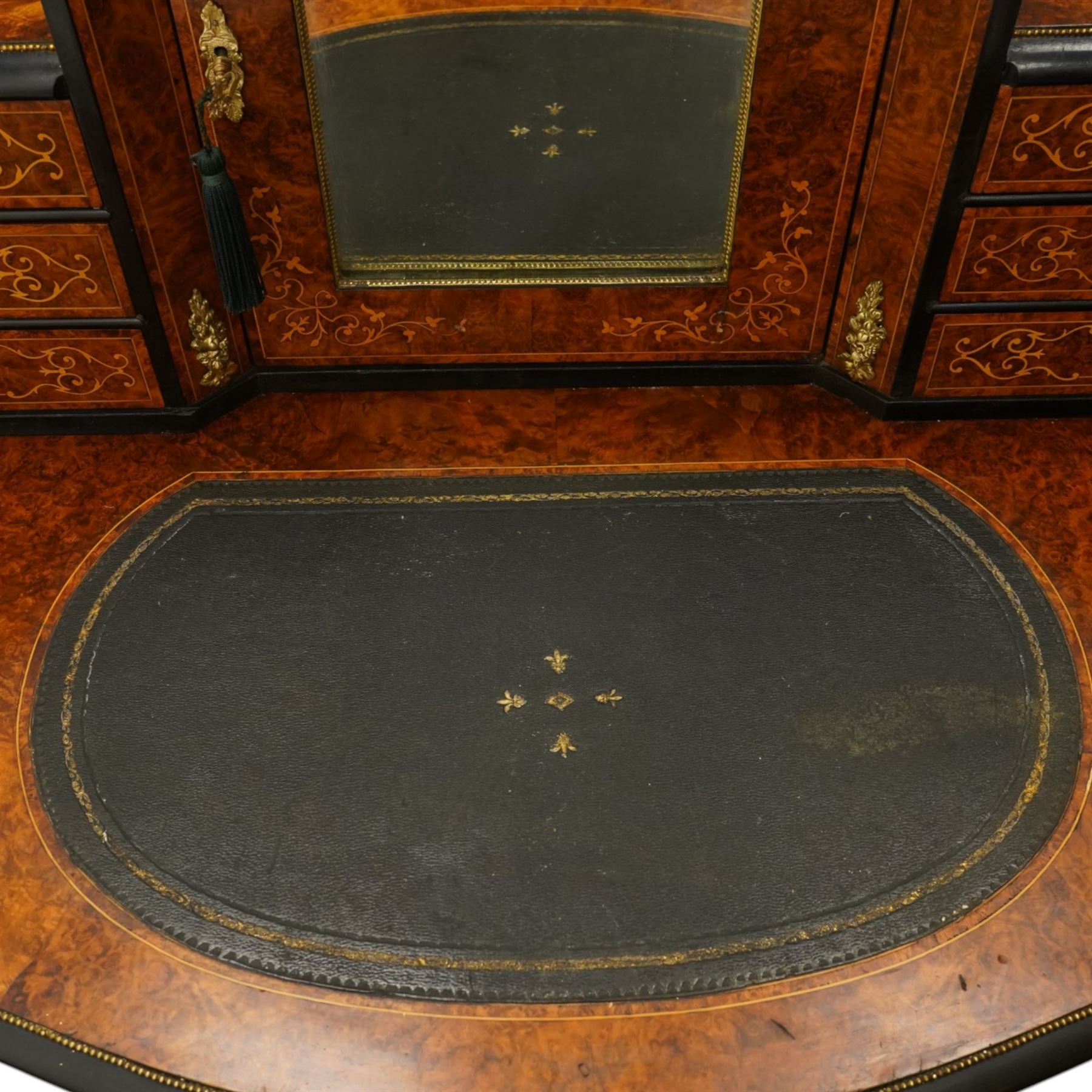 19th century French inlaid figured walnut and ebonised Bonheur de Jour or writing desk, the raised upper section with pierced brass three-quarter gallery, over a mirror glazed cupboard and a combination of drawers, the shaped and moulded top with leather inset and satinwood stringing, with brass beading too the ebonised edge, fitted with a serpentine fronted frieze drawer, raised on cabriole supports, inlaid throughout with scrolling foliate decoration in boxwood and ornate cast brass mounts and handles