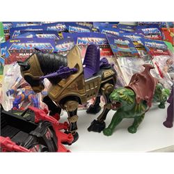 Thirty-one Masters of the Universe He-Man figures re-bagged on original backing cards;  two others lacking backing cards; boxed Modulok figure; bag of weapons and accessories; Roton, two horses and two battle cats; 1986 & 1987 Annuals; Ladybird and other story books; Panini sticker album; instructions etc