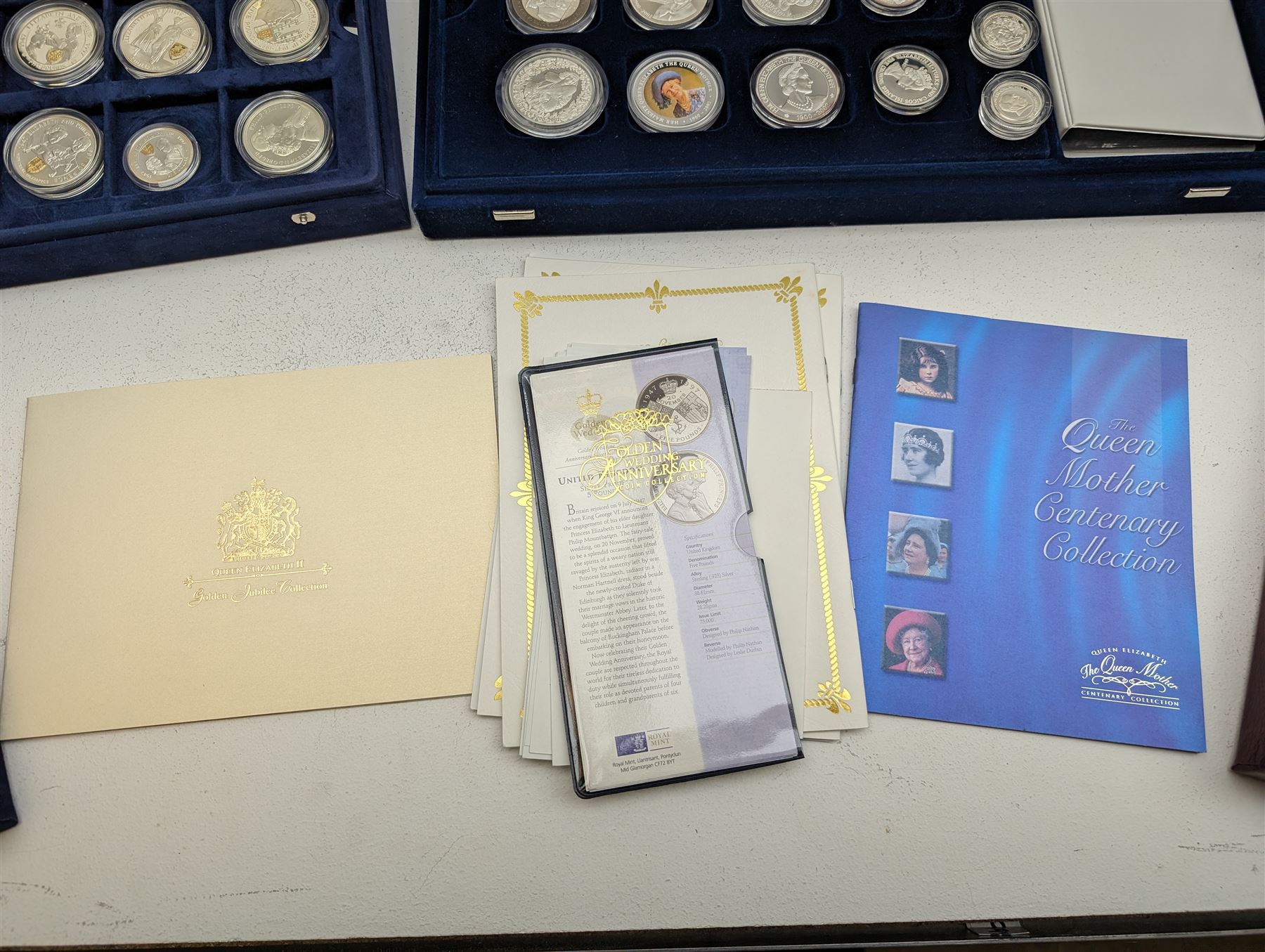 Large collection of modern commemorative coins, mostly being silver proof, including Queen Elizabeth II Bailiwick of Guernsey 1999 'Sir Winston Churchill' one pound, 2000 'HM Queen Elizabeth The Queen Mother', various sterling silver proof coins from the 'Golden Wedding Anniversary Silver Collection' including Bailiwick of Guernsey 1997 five pounds, Bermuda 1997 two dollars, Republic of Malawi 1997 five kwacha, Falkland Islands 1997 five pounds, Bailiwick of Jersey 1997 five pounds, Alderney 1997 two pounds etc, various sterling silver proof and portrait highlighted in gold coins from the 'Golden Jubilee Collection' including Cayman Islands 2002 two dollars, Bailiwick of Guernsey 2003 five pounds etc, housed in various coin displays or cases, mostly with certificates
