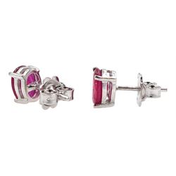 Pair of silver oval ruby stud earrings, stamped 925