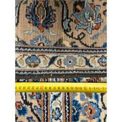 Northwestern Persian Tabriz hand-knotted carpet, the ivory ground with an all-over repeating Herati pattern of stylised palmettes, rosettes and serrated leaves in shades of indigo, terracotta and sky blue, framed by a dark blue border of arabesque vines and scrolling foliage between floral guard stripes, from the region of Tabriz