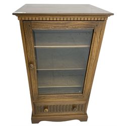 Ercol - mid-20th century dark elm 'Old Colonial' music cabinet, single glazed door enclosing three shelves, single drawer fitted to base