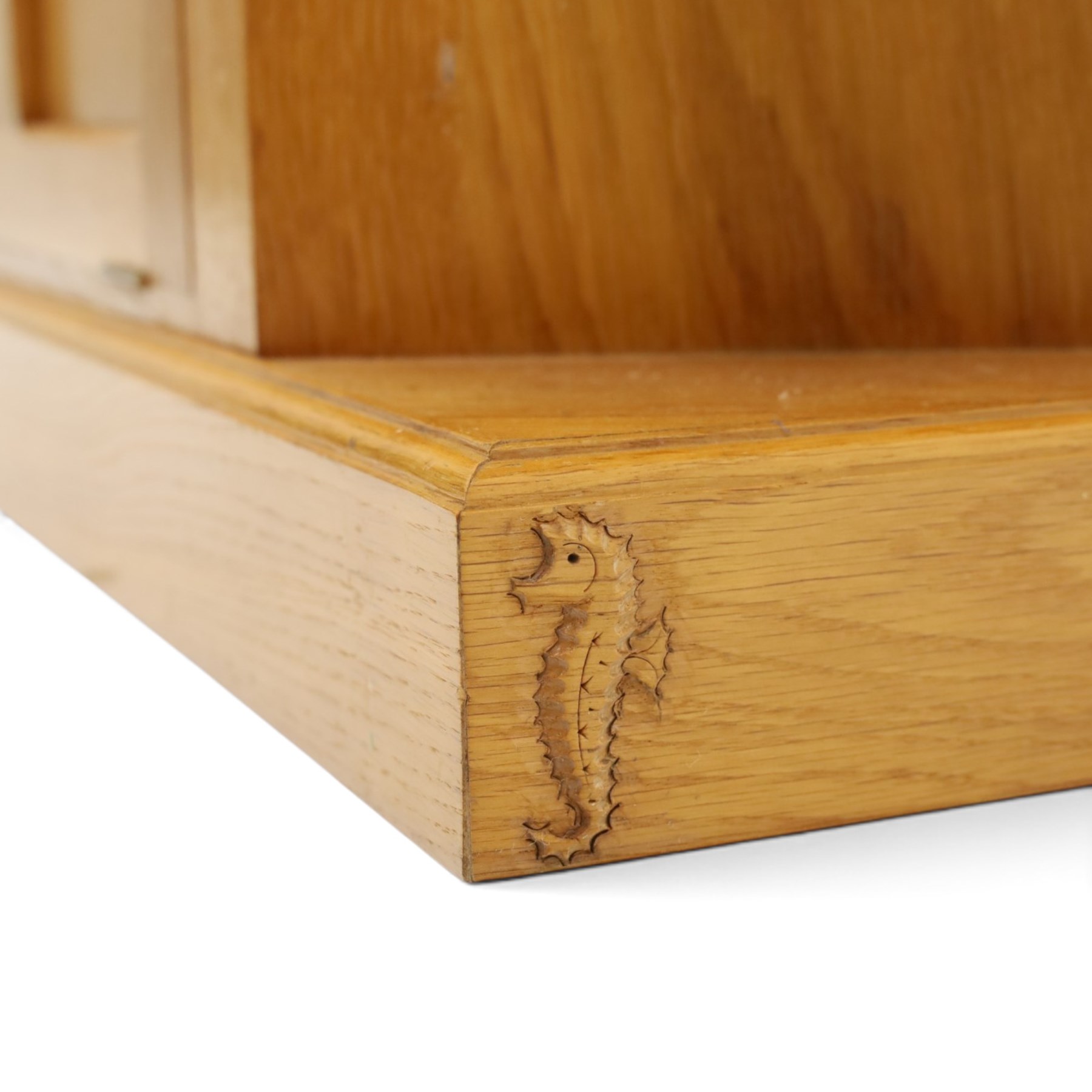 Seahorseman - craftsman made Yorkshire oak corner media unit, fitted with two panelled fall-front compartments flanked by open corner shelves, carved with seahorse signature, by Shaw and Michael Riley, Hessay, York
