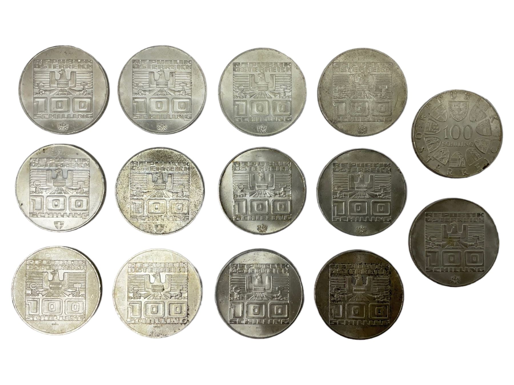 Fourteen Austria silver 100 Schilling coins, four dated 1975 and ten dated 1976, commemorating The 1976 Winter Olympic games