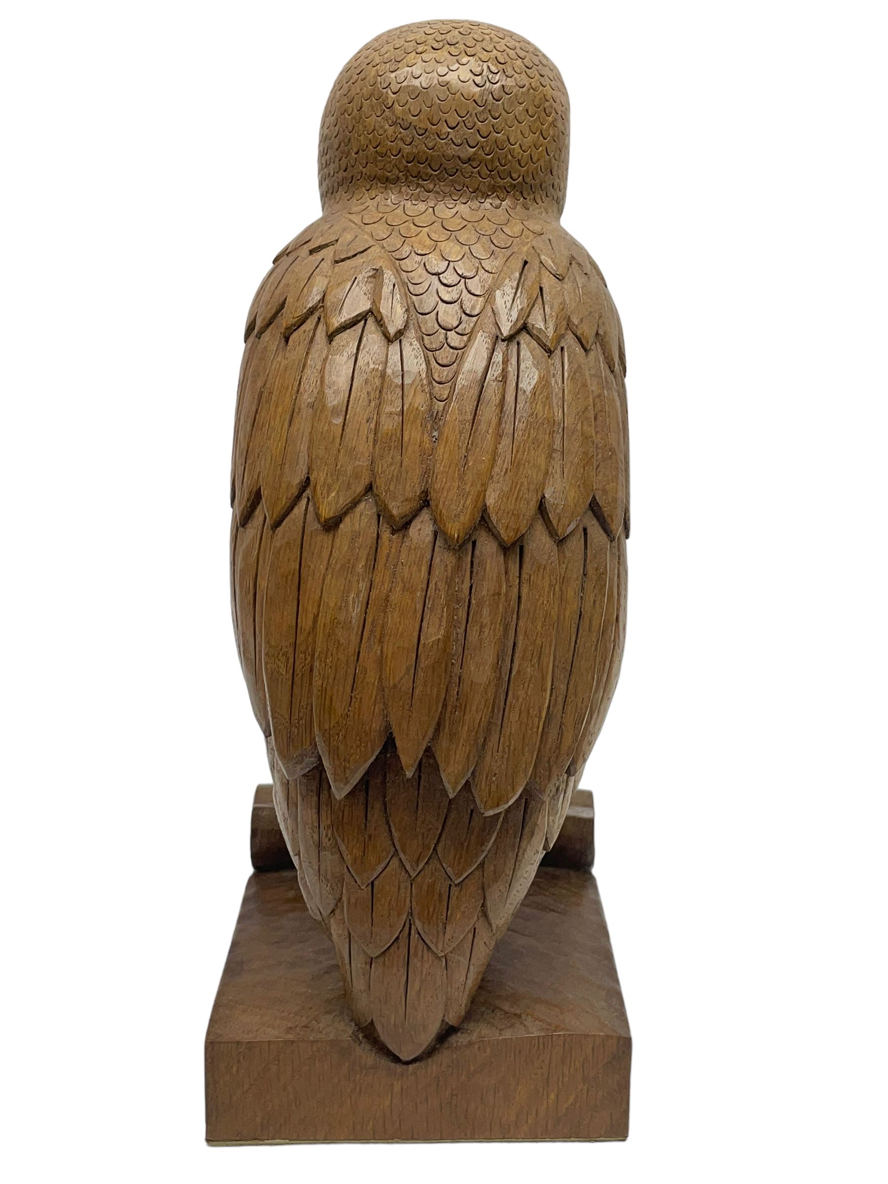 Acornman - carved oak owl perched on branch, on tooled block plinth carved with acorn signature, by the workshop of Alan Grainger, Brandsby (carved by Norman Darnley)