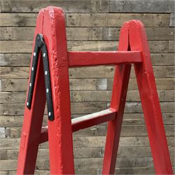 Pair of vintage red painted A frame trestles, with original A W Oates Painter signage