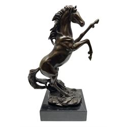 Bronze figure, modelled as a rearing horse, upon a rectangular black marble base, H27cm