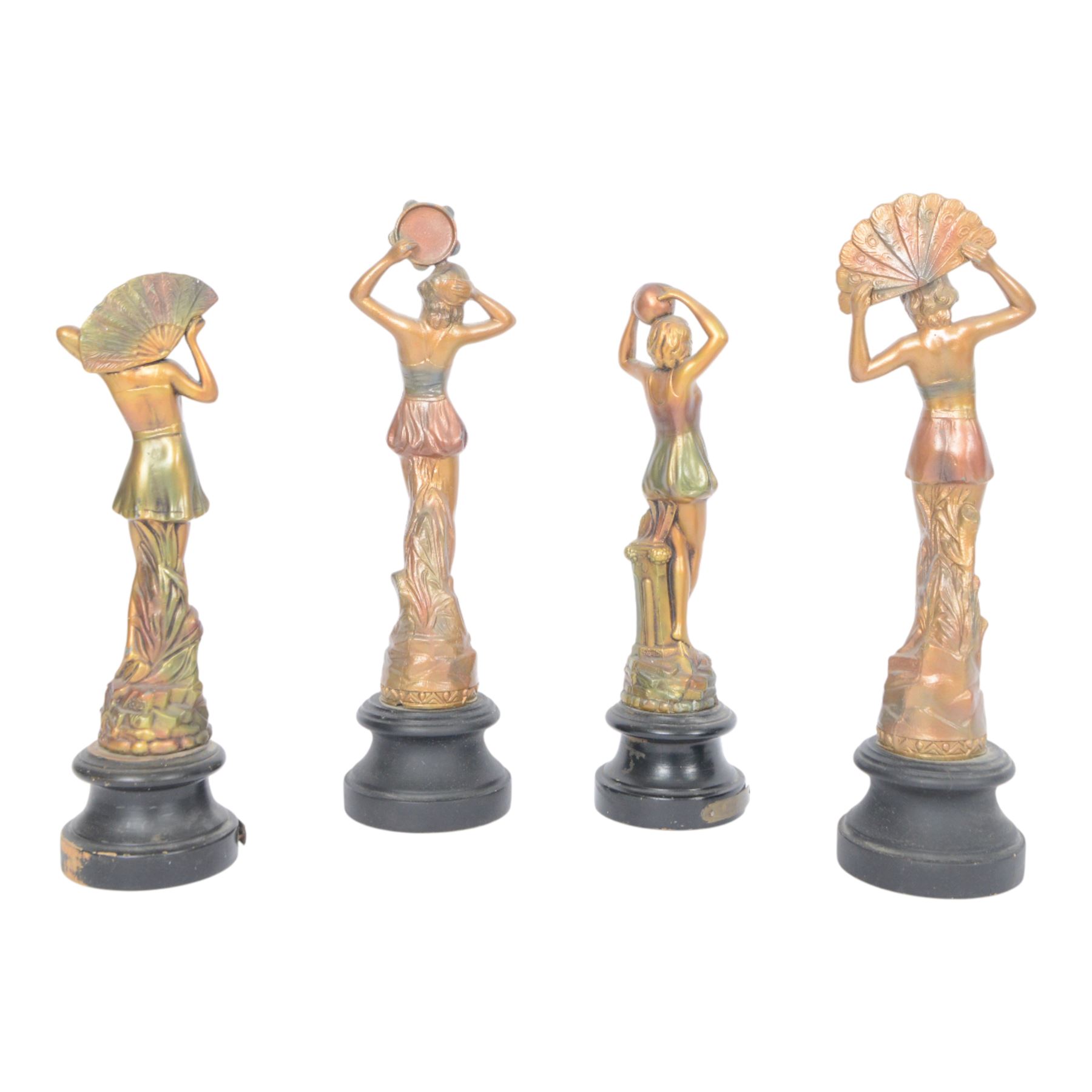 Four Art Deco style figures, modelled as dancers in various poses, finished in gilt and upon wooden plinths, H33cm