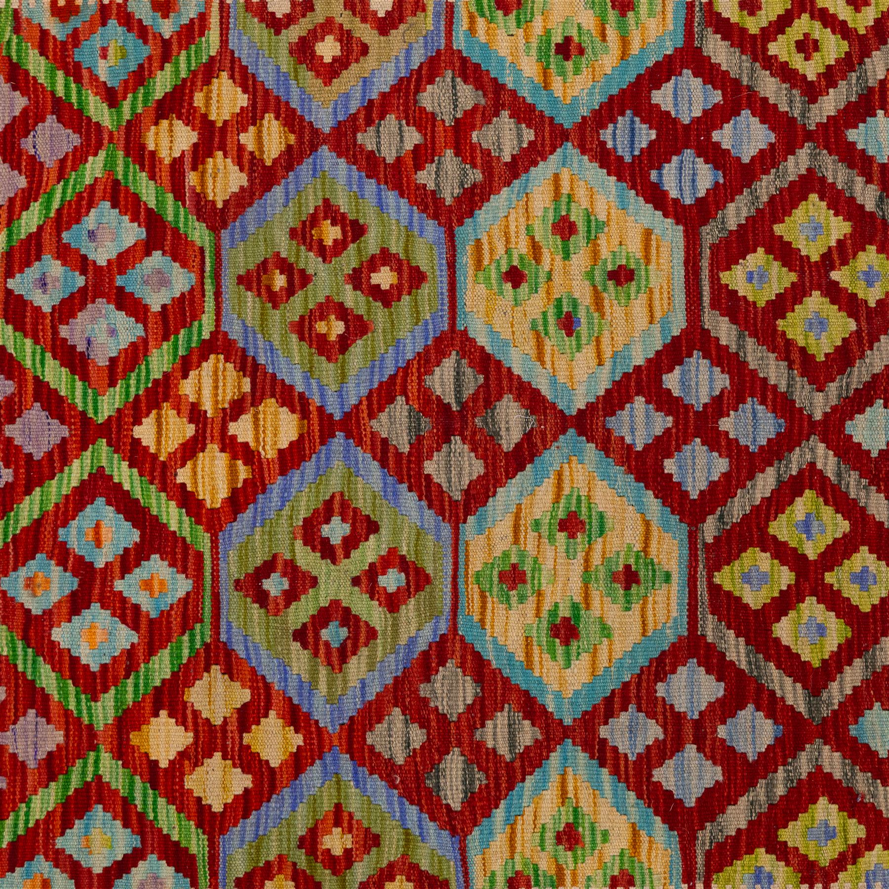 Turkish Anatolian flatweave kilim runner, ivory field decorated with rows of large polychrome lozenge medallions enclosing stylized geometric motifs with angular stepped borders, fringe ends 