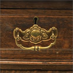 Oak twin pedestal desk with leather top, moulded rectangular top with inset black leather writing surface, nine fielded panelled drawers with brass handles, raised on a plinth base with castors