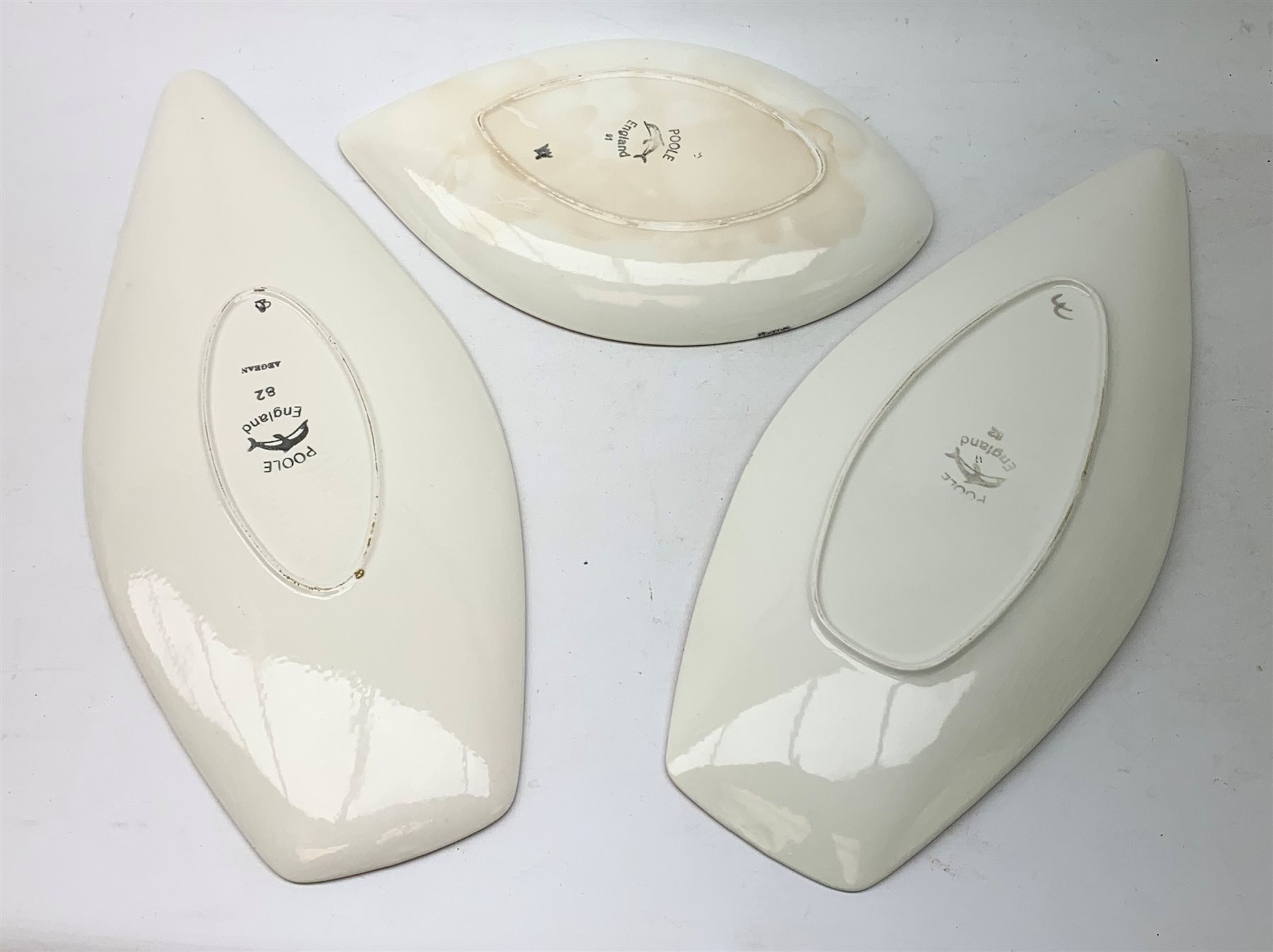 A Poole Pottery Aegean spear dish, together with a Delphis example, each shape 82, largest L44cm, and a Poole Delphis tear plate, shape 91, L30.5cm, each with printed mark beneath.