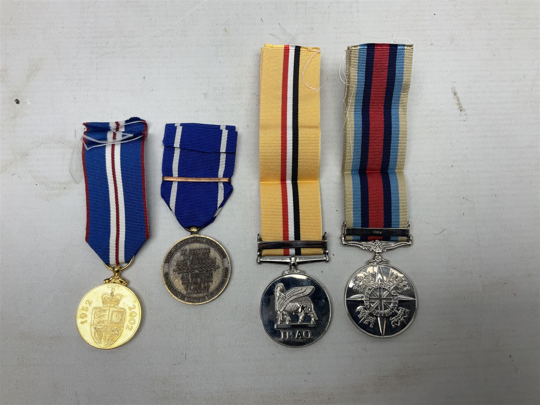 NATO Service Medal with clasp for Former Yugoslavia; together with three copy medals - Iraq Medal with clasp for 19 Mar to 28 Apr 2003 and unfitted rosette; Operational Service Medal with Afghanistan clasp; and QEII Golden Jubilee 2002 medal; all with ribbons (4)