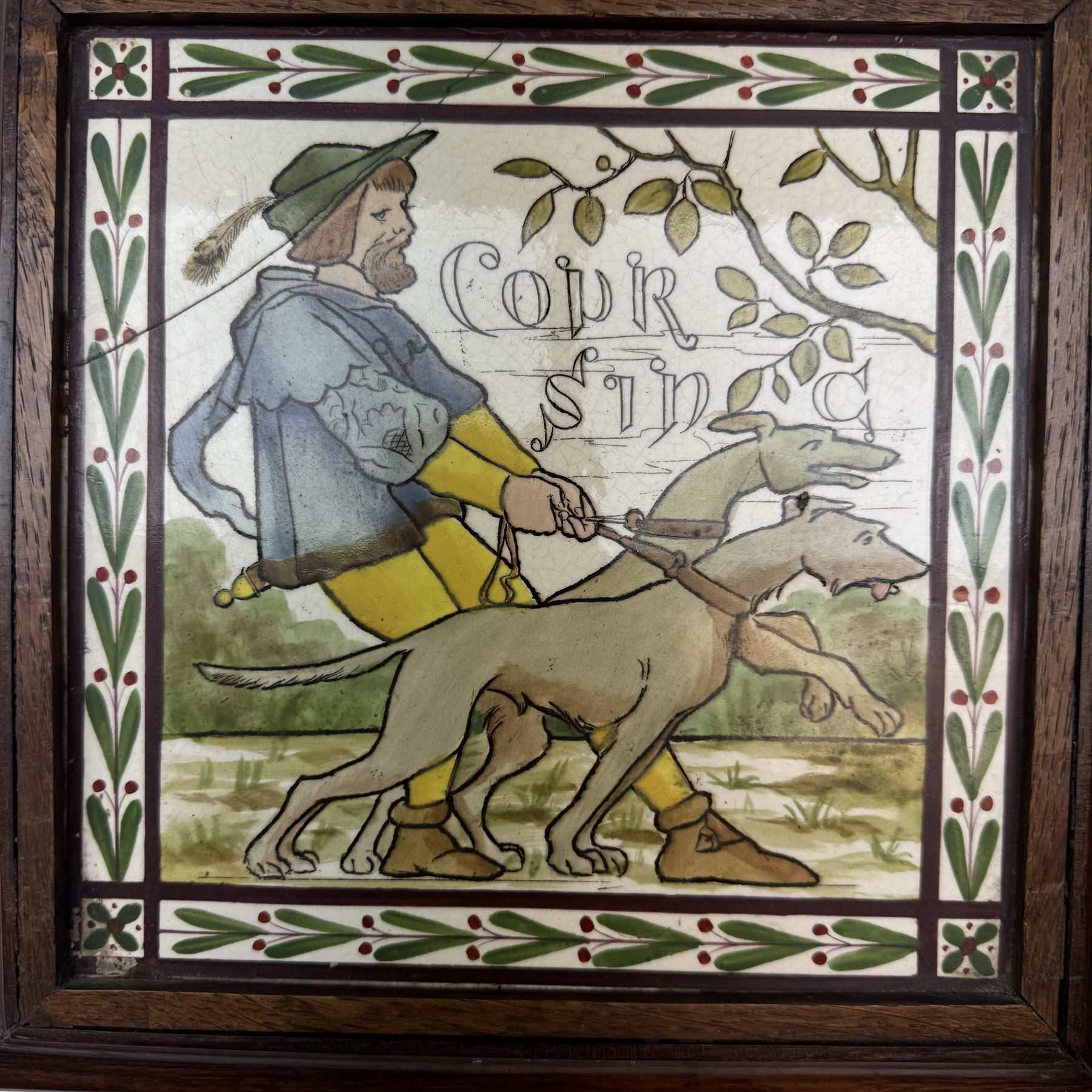 Pair of Victorian tiles, the first depicting a man with a pair of hunting dogs, the other a woman playing croquet each within a foliate boarder, within oak frames, H25cm, 