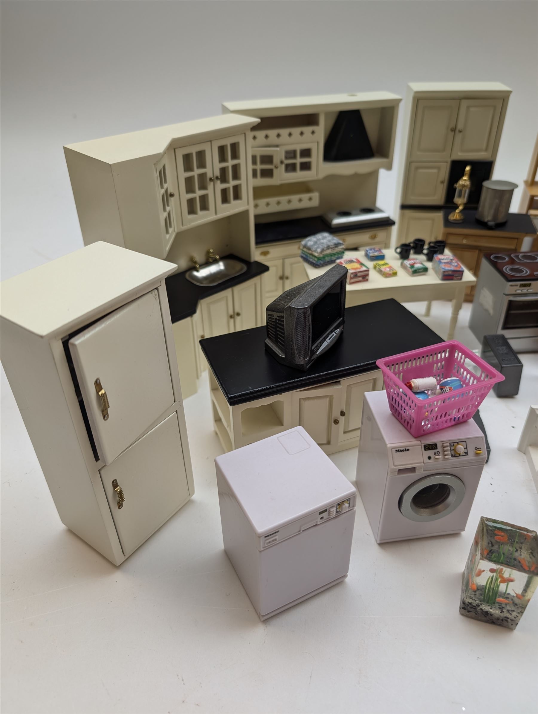 Modern 1:12 scale dolls house furniture, comprising pine kitchen set, with wall cabinets, floor cabinets and sink unit, white wooden bathroom suite, white wooden kitchen and dining room furniture and appliances, wooden bedroom furniture, Raine purple wingback chair, tv, desk, fish tank, etc