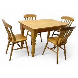 Light wood kitchen table; set of four chairs,  chairs have a shaped top rail over four ver...