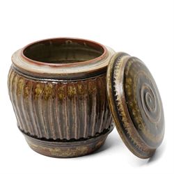 Mike Dodd (1943-): Covered studio pottery storage jar, of fluted barrel form, impressed marks to foot, H20cm 
