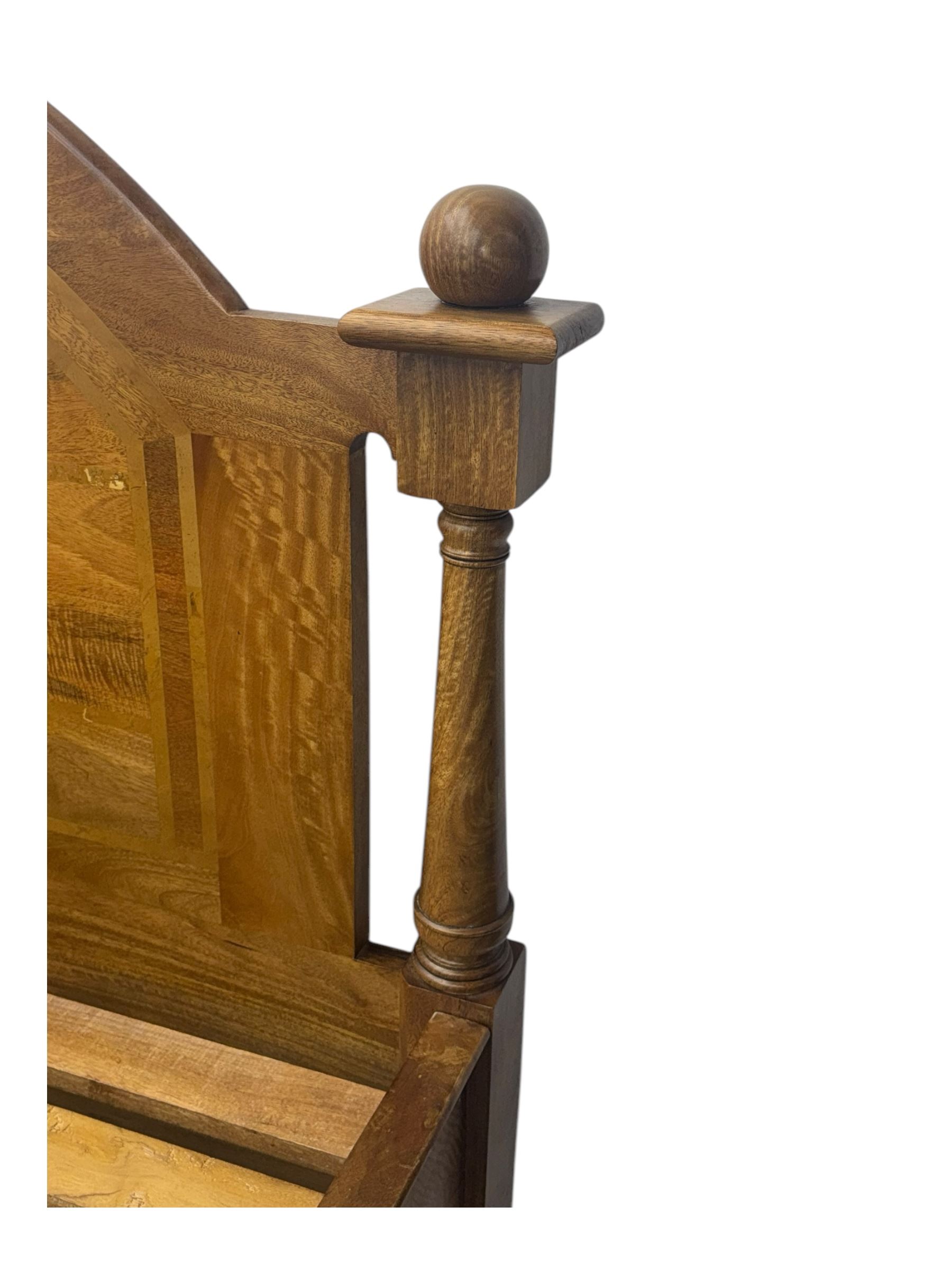 Contemporary mango wood bed frame, comprising an arched panelled headboard and footboard with inlaid geometric patterns, turned posts with spherical finials, and complete with side rails and slatted base