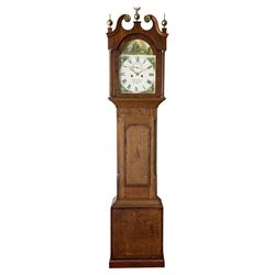 An oak and mahogany longcase clock by William Hewson, Lincoln c 1860, with a swans neck pediment, ball and spire finials and brass paterae, break arch hood door flanked by reeded pilasters with brass capitals, oak trunk with canted corners and a short oak door with mahogany crossbanding, conforming plinth with applied skirting, fully painted dial with Roman numerals, minute track and subsidiary seconds dial, matching brass stamped hands and winding collets, depiction of a  sportsman to the break arch and corresponding game birds to the spandrels, dial pinned directly to an eight-day rack striking movement with a recoil anchor escapement, striking the hours on a bell. Original casemakers label pasted to the inside of the case 