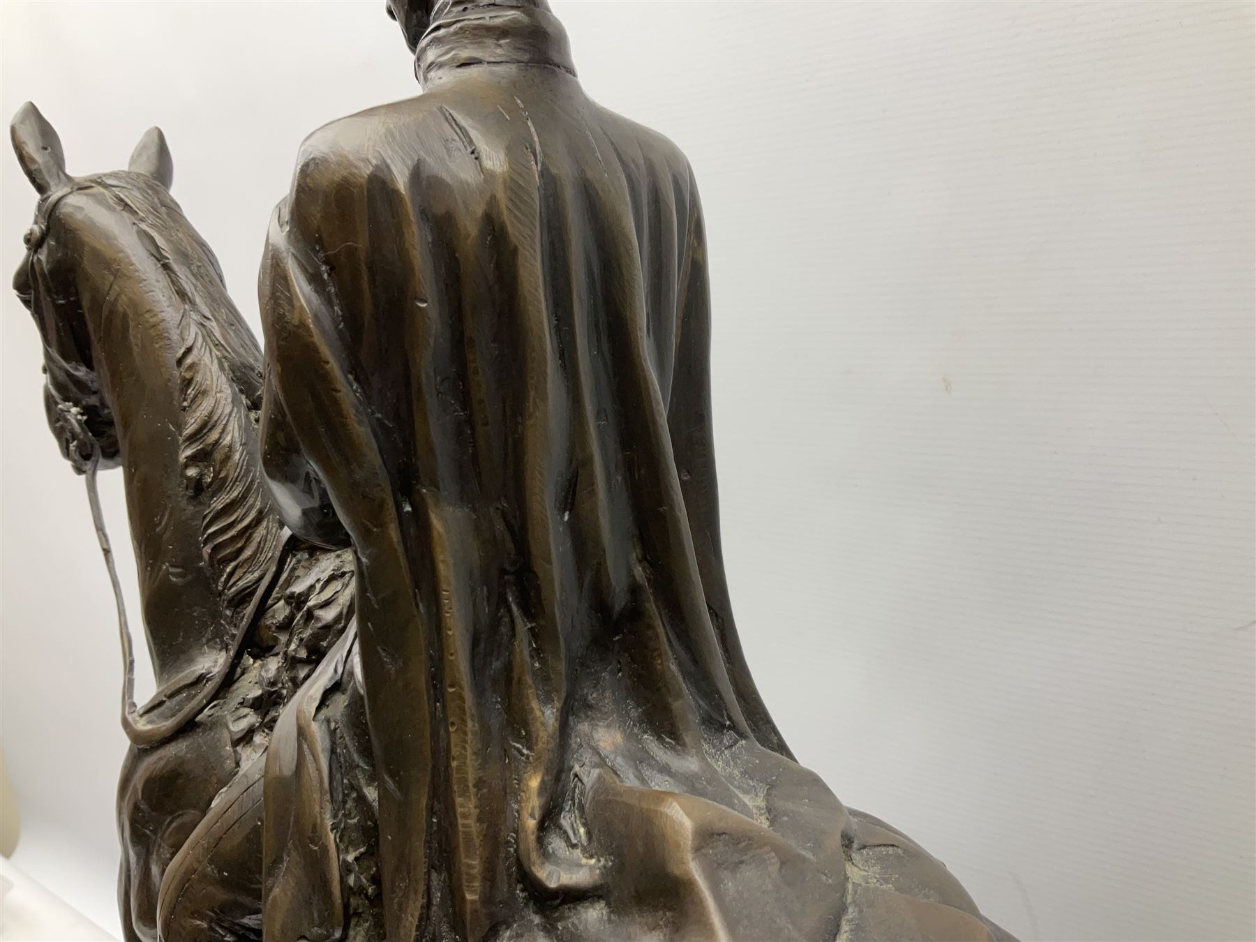 Large and impressive bronze figure of Wellington seated on a horse, on a sarcophogus shaped stepped base impressed 'Meunier Paris', the canted corners inset with battle trophies H68cm L50cm D22cm