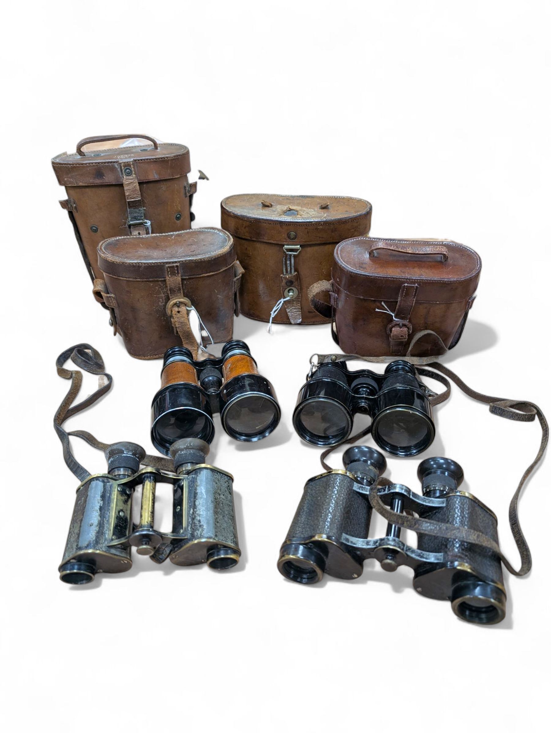 Four pairs of early 20th century binoculars, including Carl Zeiss Jena Feldstecher binoculars, Carl Zeiss Telact 8x binoculars, Dollond x5 field binolculars and one other pair, all in leather cases, one case marked with broad arrow, some with officers name etched