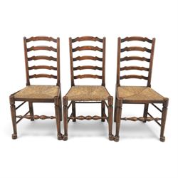 19th century set of six ash and elm ladderback dining chairs, shaped ladder backs above rush seats, raised on turned front supports with pad feet, united by turned stretchers