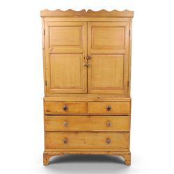 19th century waxed pine press cupboard, shaped cornice above a twin fielded panelled cupbo...