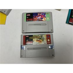 Two Super Nintendo Entertainment System (PAL) controllers, accessories and games. Super NES Game Commander with original box and instruction booklet, Super NES Nintendo Scope (1992) transmitter gun, receiver, Super NES Nintendo Scope 6 game with original instruction booklets. Further games to include ‘The Legend of Zelda a Link to the Past’, ‘Super Mario World’, ‘Super Mario Kart’, ‘The Lawnmower Man’, and ‘Exhaust Heat’, all with original instruction booklets. ‘PowerMonger’ and Disney’s ‘Aladdin’ game cartridges only 