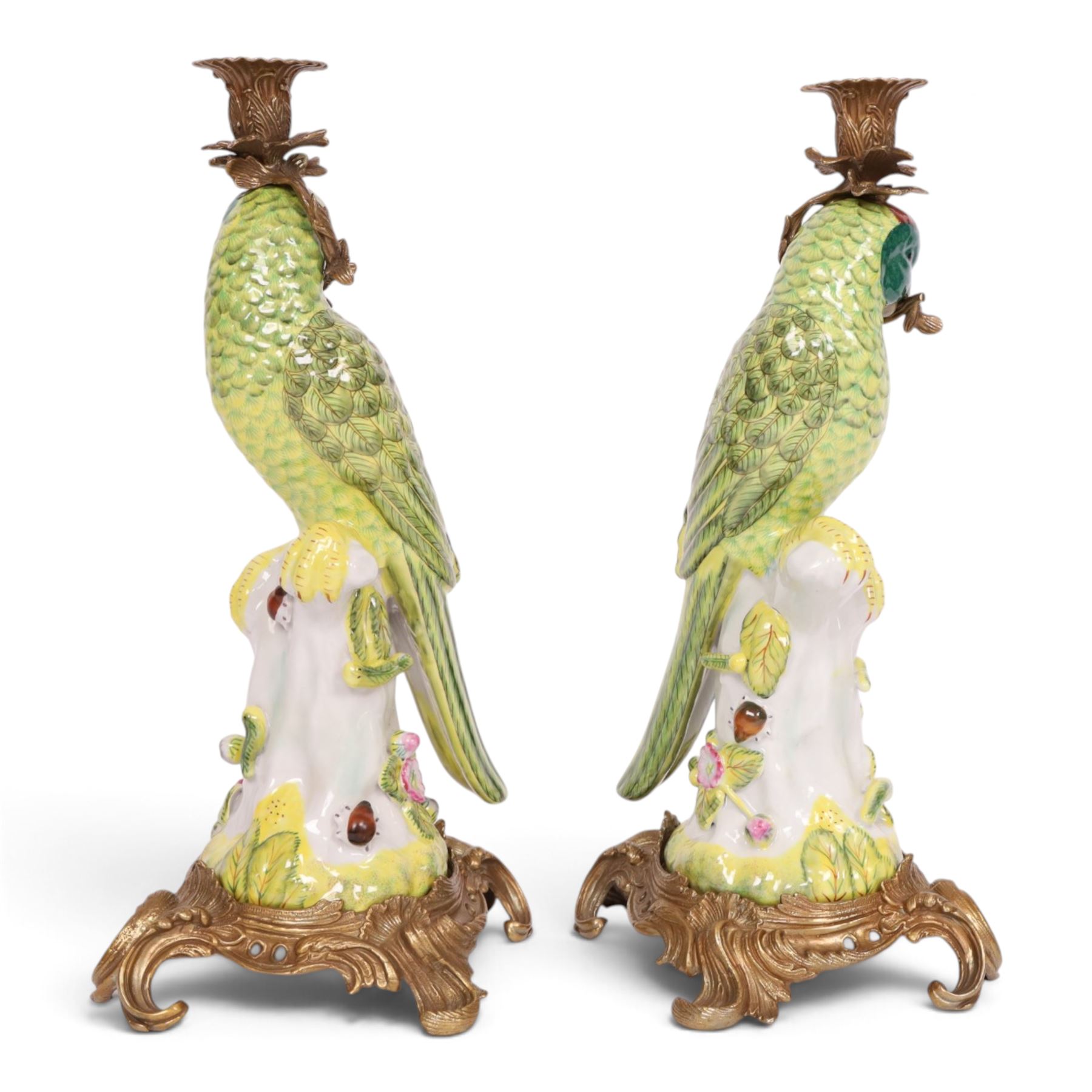 Pair of candlesticks, modelled as green parrot upon a flowering branch, upon four gilt acanthus leaf feet, H36cm