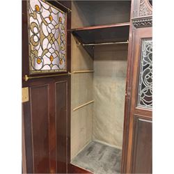 Victorian mahogany wardrobe, projecting cornice over cushion moulded frieze carved with cartouche and scrolls, the left hand compartment enclosed by stained glass panel glazed door with Gothic arched panels, the right hand side enclosed by bevelled mirror glazed door, fitted with open top box, carved with acanthus leaf and gadroon decoration, egg and dart moulded and dentil frieze cornice, stepped and moulded plinth base