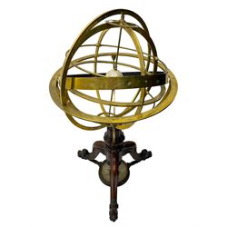 19th century brass terrestrial armillary sphere on rosewood base, lobe carved column on three splayed supports with scrolled carved terminals, the supports united by circular compass with turned stretchers