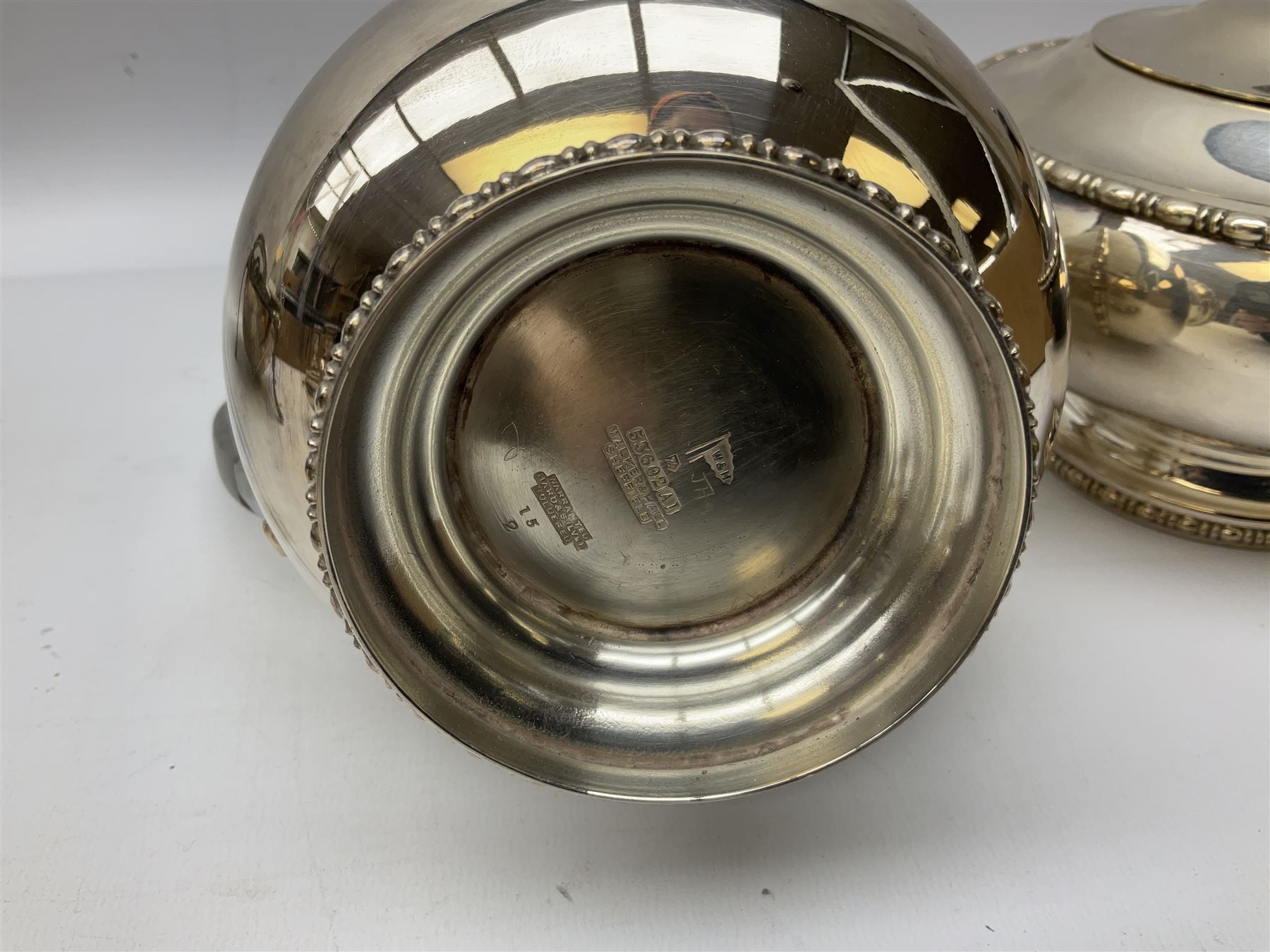 Collection of silver plate to include pair of Falstaff dwarf candlesticks in the 'Adam' style, weighted and raised upon fluted oval bases, together with Walker & Hall coffee pot, teapot, twin handled sucrier and jug in pattern no. 53602, and a Finnigans of Manchester entrée dish, the revolving top with engraved monogram