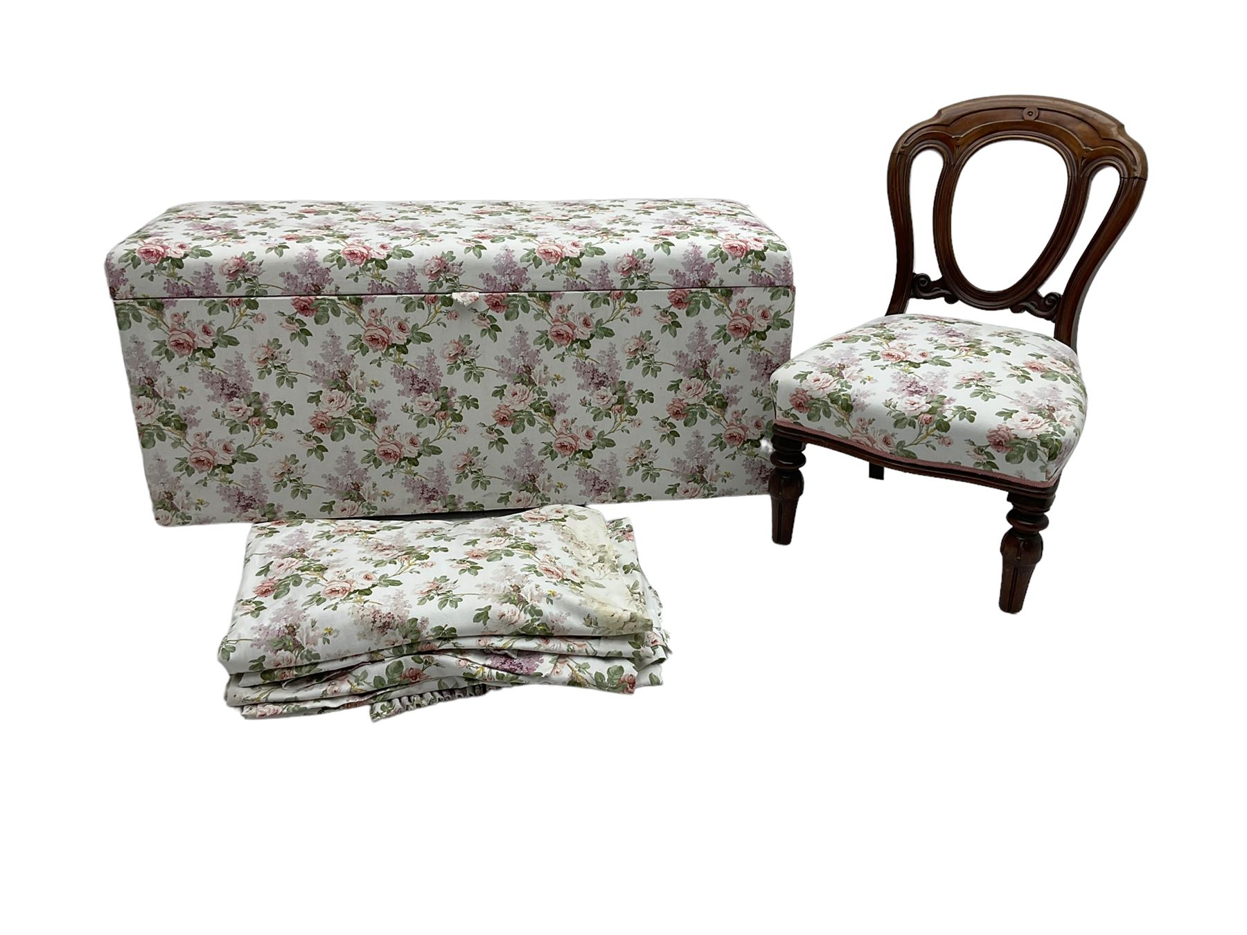 Ottoman blanket box upholstered in floral pattern fabric, matching bedroom chair and curtains