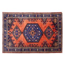 Central Persian Veis hand-knotted carpet, madder red field, decorated with a repeating arr...