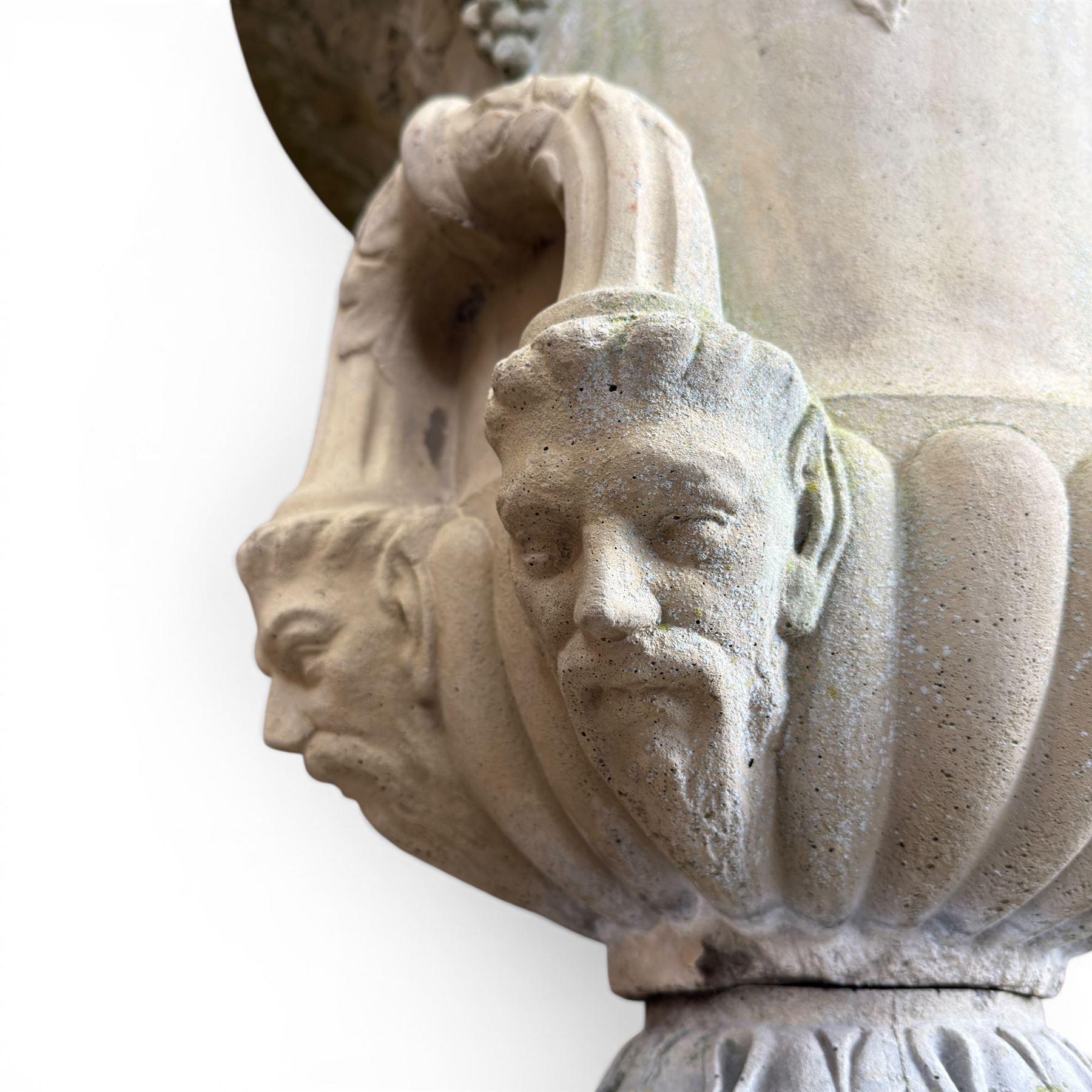Cast stone classic garden urn, the rim decorated with leaves and berries, twin handles with face masks, raised on square base, stamped HGC