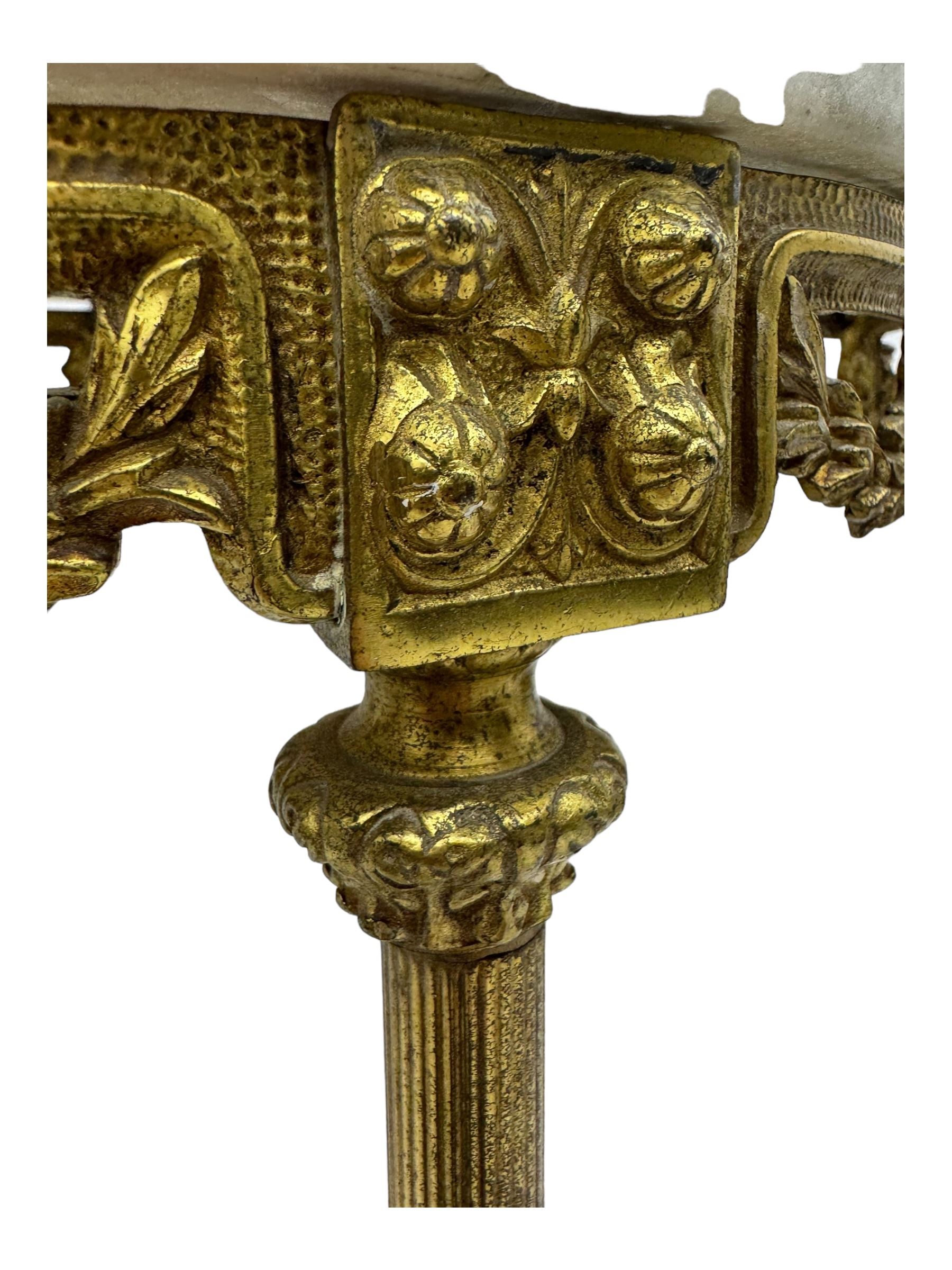 Late 20th century cast gilt metal and marble two-tier stand, pink and grey marble top and undertier, the base decorated with floral garlands, on reed moulded supports with splayed terminals 