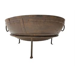 Circular riveted iron fire pit, strapwork sides with twin handles on stand, with grate