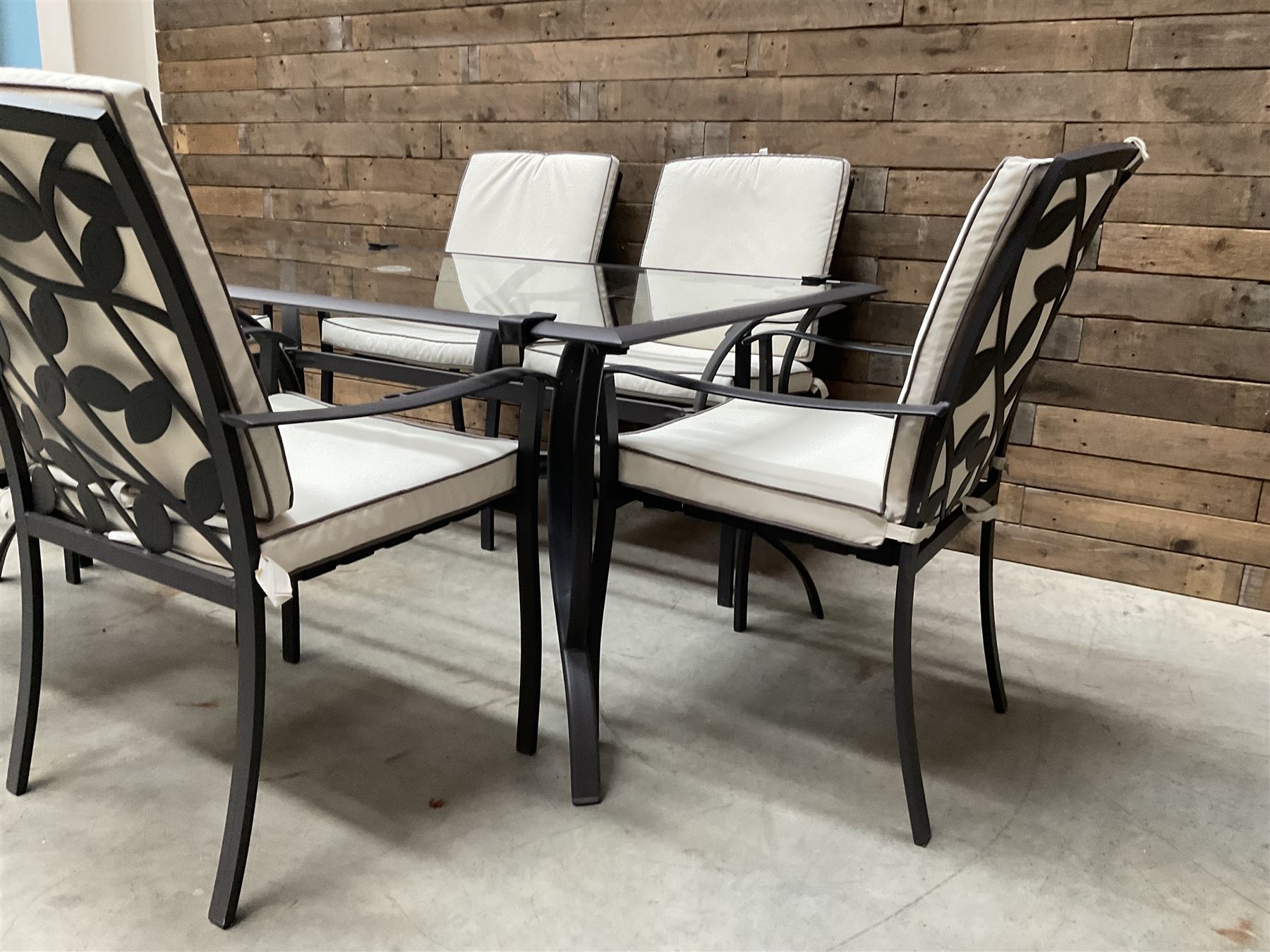 Metal framed garden table with glazed top (W170cm, D102cm, H71cm) and six armchairs with cushions 