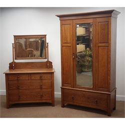  Arts & Crafts period panelled oak wardrobe, enclosed by single bevel edge glazed door, single drawer to base (W116cm, H191cm, D49cm), and a matching dressing chest, raised rectangular bevel edged mirror, two short and two long drawers (W108cm, H160cm, D47cm)  