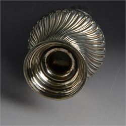 Victorian silver sugar caster, of bellied urn form, embossed with floral and foliate motifs, with two vacant cartouche, upon a domed stepped circular foot, with pierced removable cover with flambe finial, hallmarked Marston & Bayliss, Chester 1900, H25cm