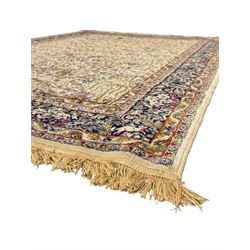 Persian Kerman ivory ground rug, the field adorned with naturalistic depictions of birds, animals and floral designs, framed by a multi-band border in blue and red tones