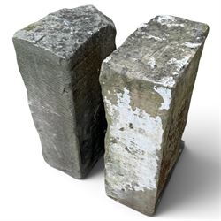 Pair of George III weathered carved sandstone architectural corbels, each with a projecting moulded capital above a half-canted baluster, waisted socle and stepped base
