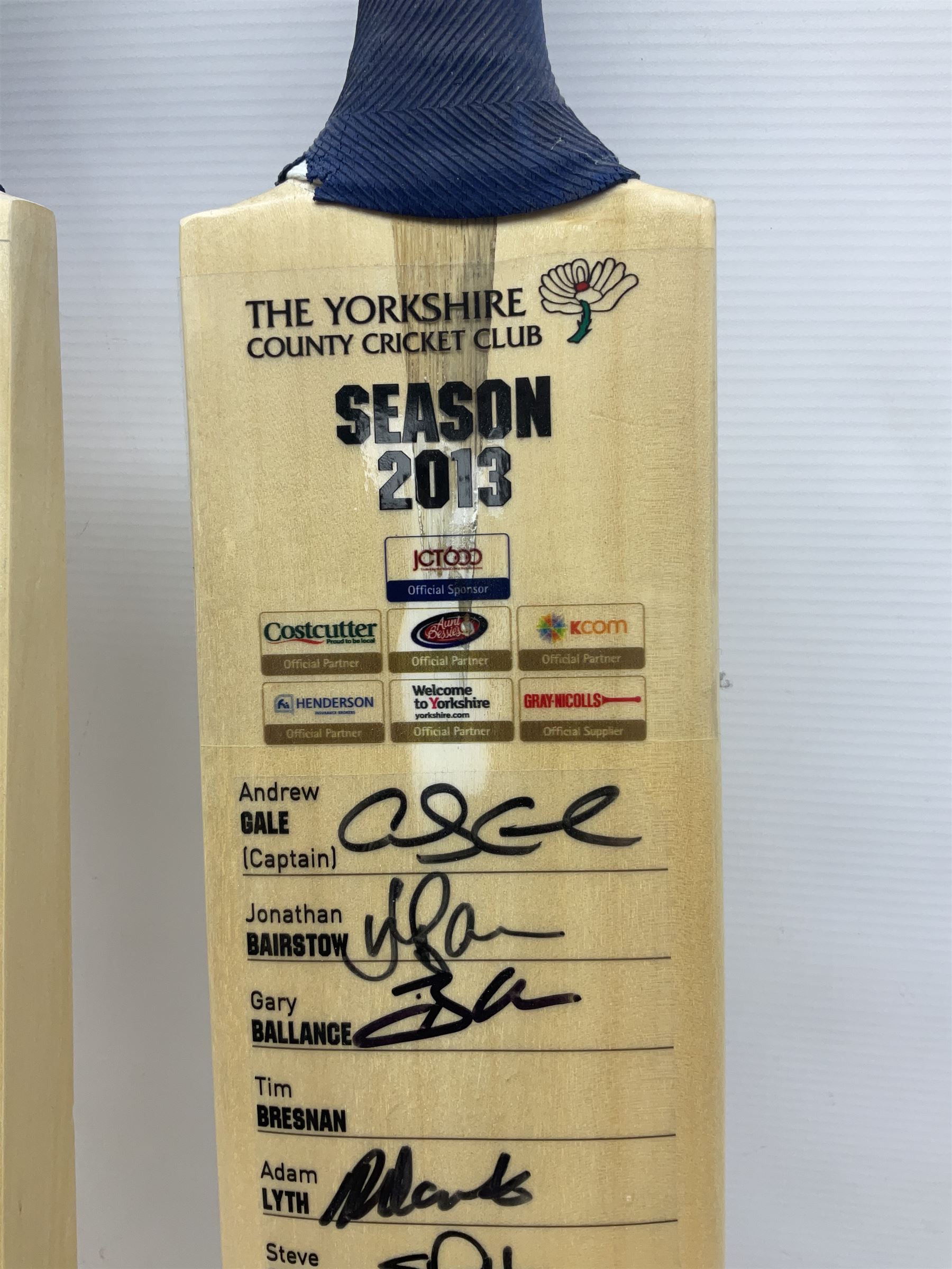 Two signed Yorkshire County cricket bats, from 2013 and 2014 seasons, bearing signatures including Johnny Bairstow, Joe Root, Tim Bresnan, Andrew Gale, etc