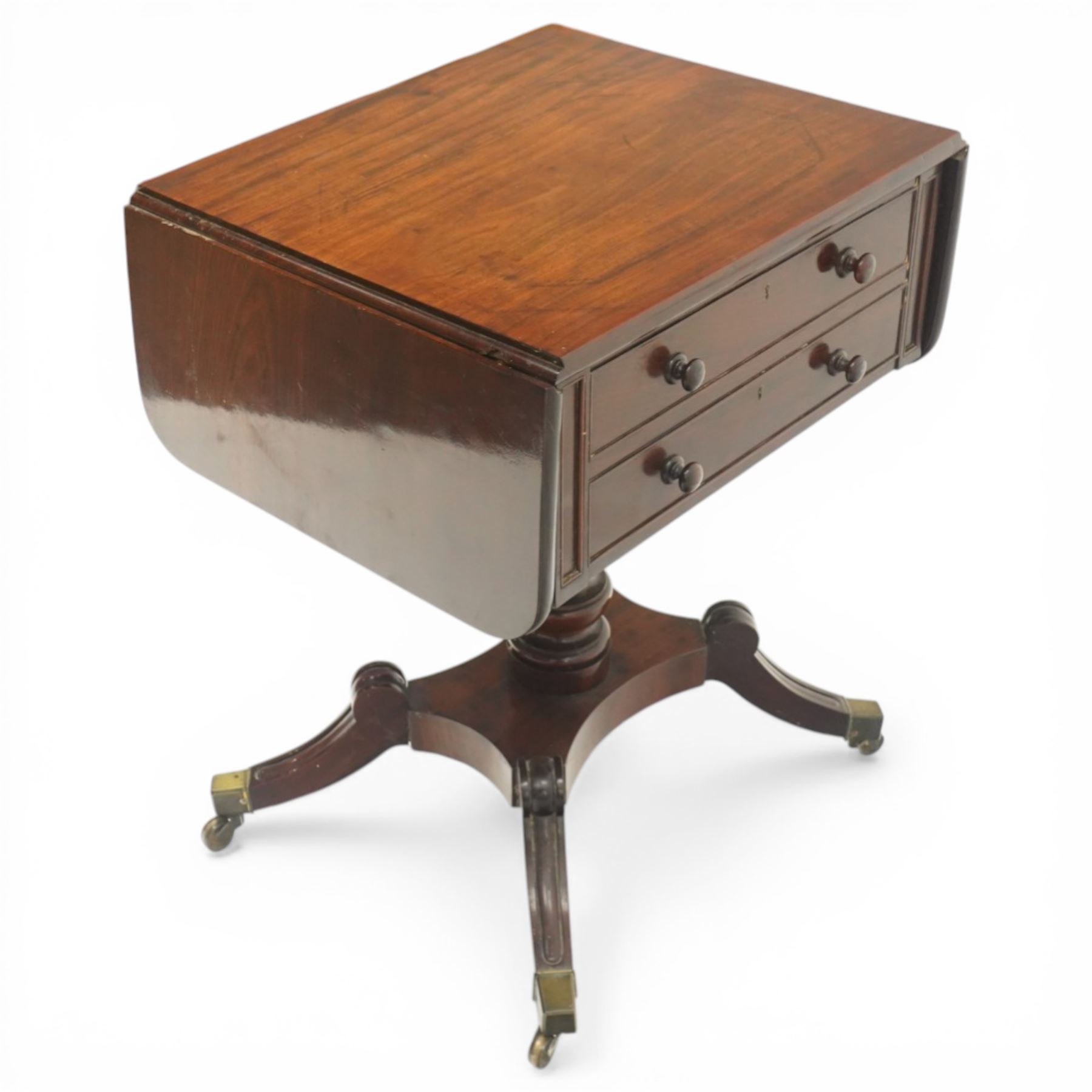 Georgian style mahogany drop leaf work table, rectangular top with rounded drop leaves over two frieze drawers with turned handles, raised on turned pedestal support with four outswept legs terminating in brass caps and castors