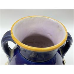 Minton majolica vase, the squat body with twin handles, with part osier moulding and applied Spring flowers against a cobalt blue ground, upon integral square base, impressed beneath Minton 1316, H16.5cm