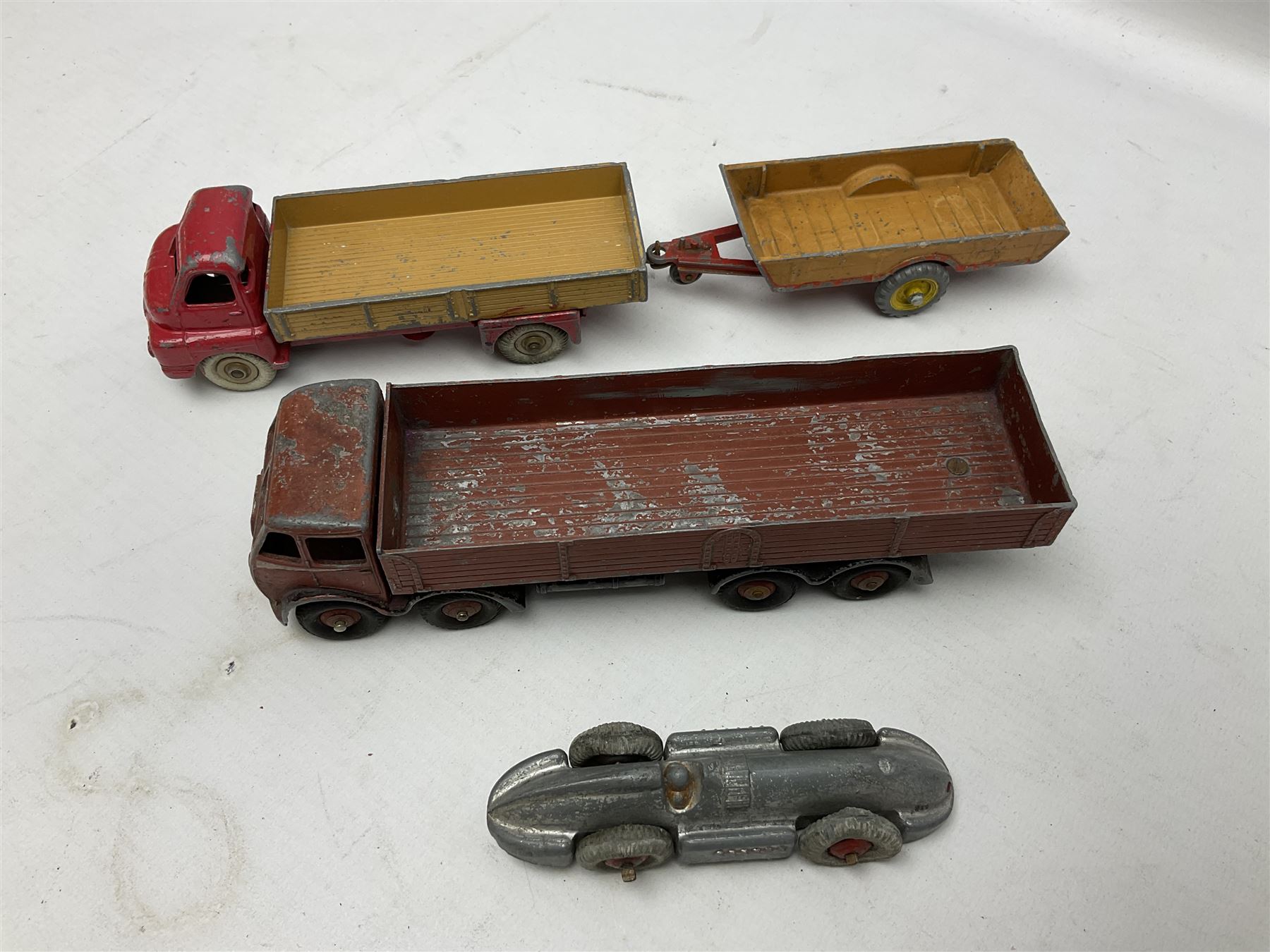Dinky - sixteen unboxed and playworn die-cast models including Foden lorry, Big Bedford lorry with Halesowen Farm Trailer, Thunderbolt land speed record car, Spirit of the Wind racing car, market garden truck, Bedford tipper, station wagon, tanker, motorcycle combination etc; two Corgi models; and five Matchbox/Lesney models (23)