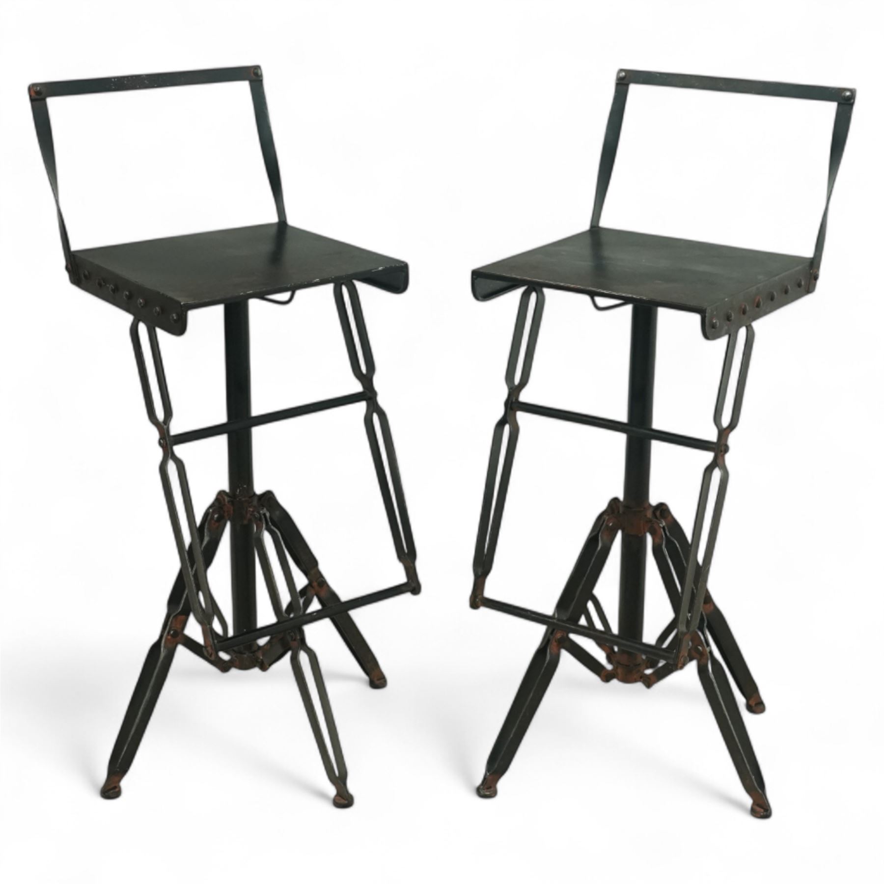 Pair of 20th century brutalist industrial metal swivel bar stools, sheet seats with strap backrests with bolted design to the sides, raised on quadripod bases with angular strut supports, the seats height-adjustable and swivelling